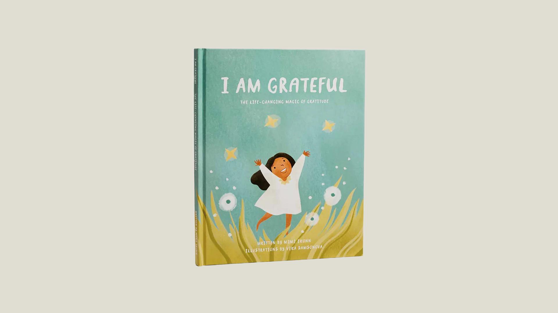 Book titled 'I Am Grateful' with a child illustration on a beige background